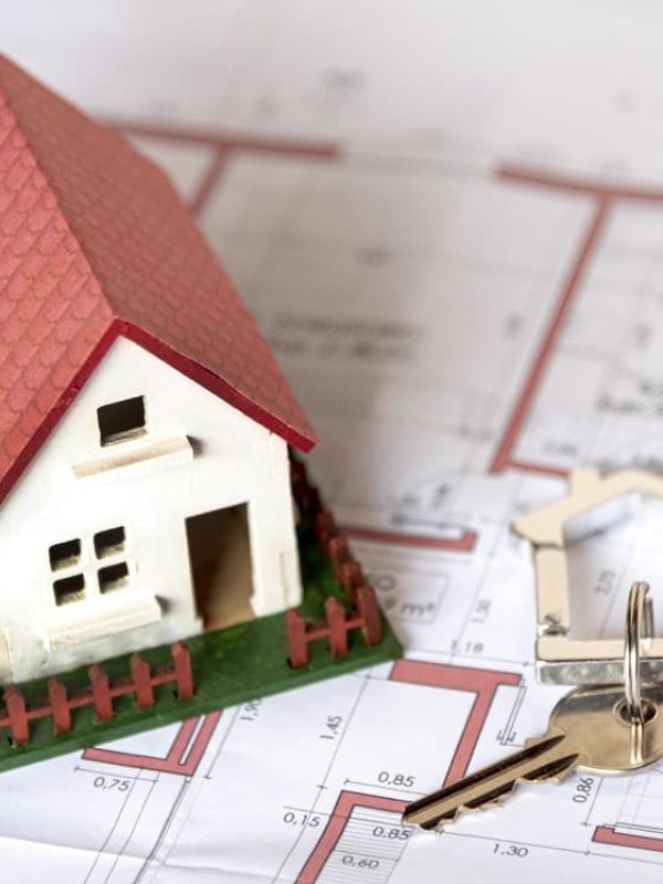 high-view-house-with-garden-and-keys-on-blueprint-min